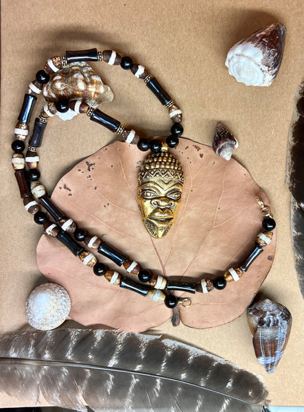 Bone, Tibetean Dzi agate, and kamagong wood necklace with ancestor mask