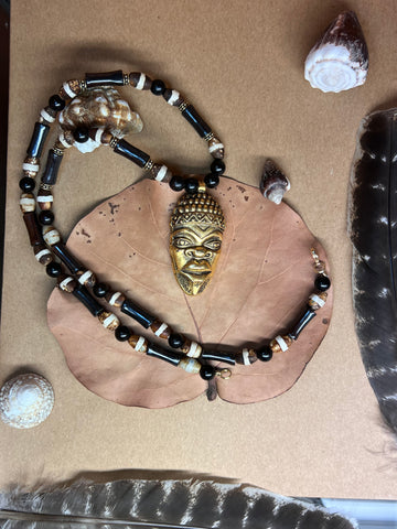 Bone, Tibetean Dzi agate, and kamagong wood necklace with ancestor mask